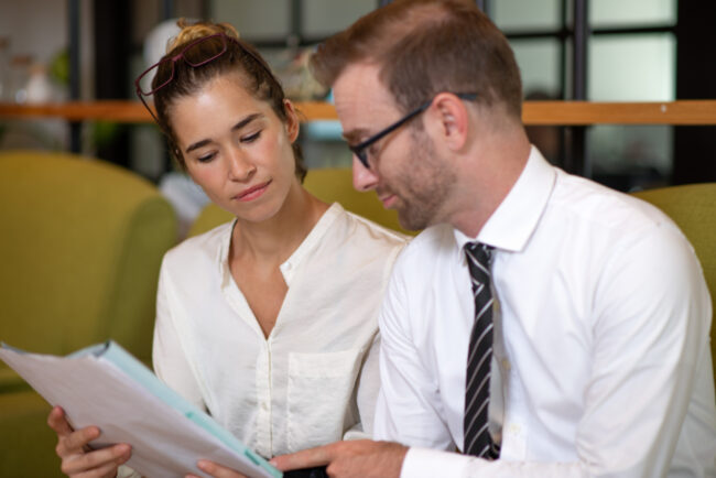 Partner buyout financing meeting with owners reviewing business documents