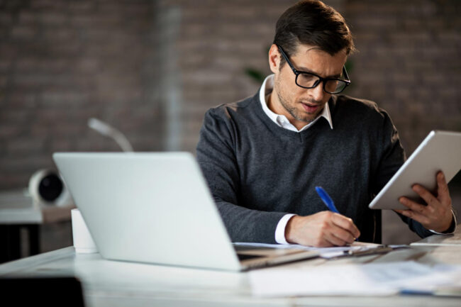 816 business owner planning business loan strategy with financial documents