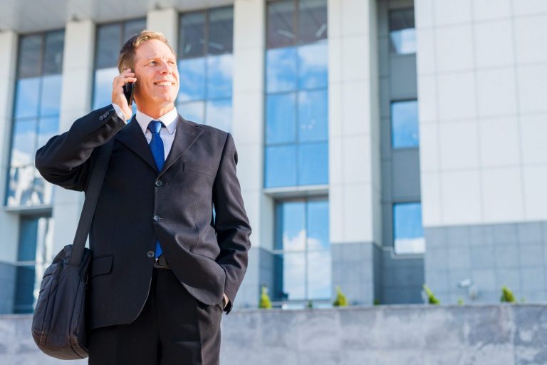 Businessman in front of building illustrates blog: Can SBA Loans Be Used to Purchase Commercial Real Estate?
