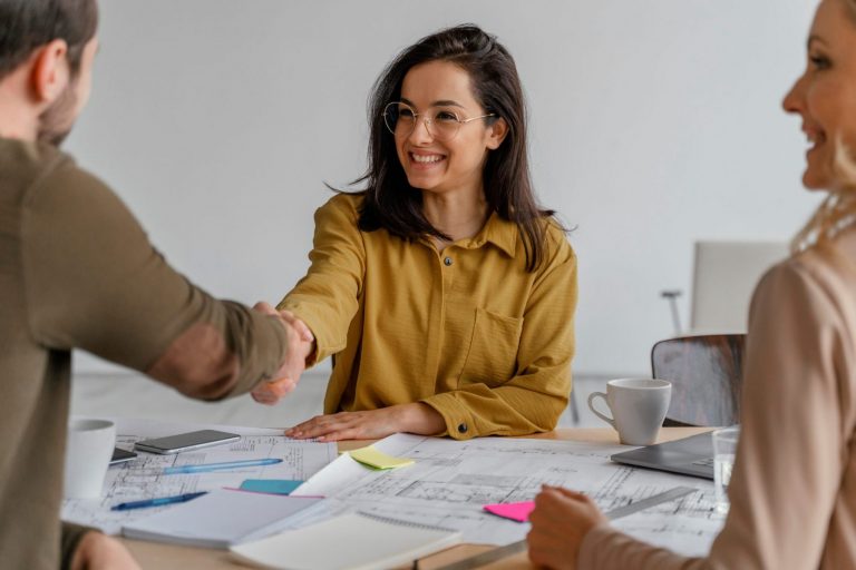 Photo of man and woman shaking hands illustrates blog: "What Type of Loan Do I Need if I Want to Purchase an Existing Business? "