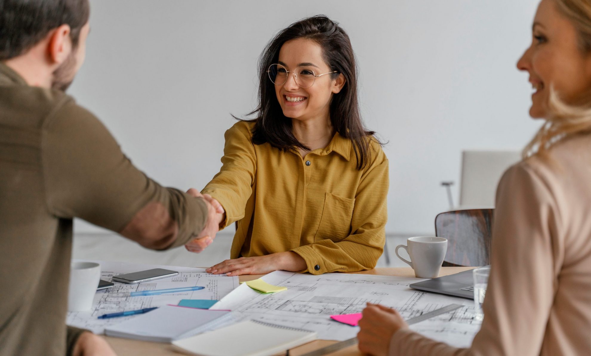 Photo of man and woman shaking hands illustrates blog: "What Type of Loan Do I Need if I Want to Purchase an Existing Business? "
