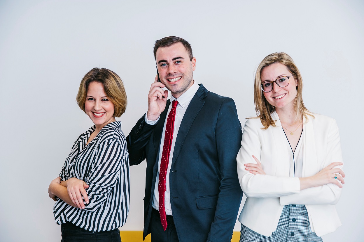 Two women and a man in business attire illustrate blog "Business Loan vs Line of Credit: Which One is Right for You?"