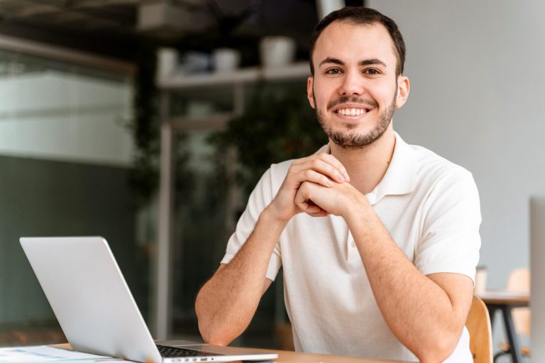 Casual businessman with laptop illustrates blog "4 Tips To Establish Business Credit"