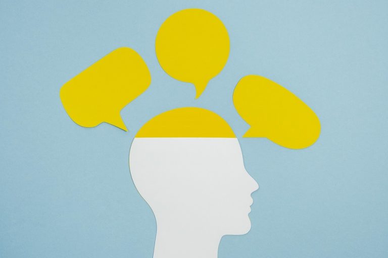 Profile of man with speech bubbles around him illustrates blog "Emotional Intelligence and Your Money"