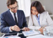 Business owner reviewing loan covenants with financial documents