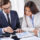 Business owner reviewing loan covenants with financial documents