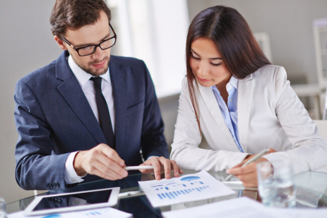 Business owner reviewing loan covenants with financial documents