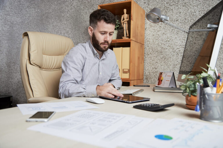 image-business-owner-reviewing-a-loan-amortization business owner reviewing a loan amortization schedule and financing costs