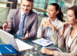 Professionals reviewing commercial loans capitalize market strategy and planning documents