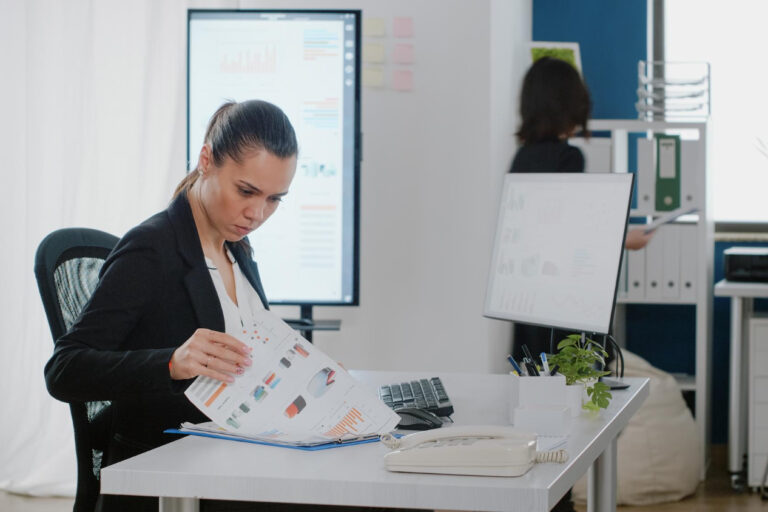 Professionals reviewing determine right borrowing amount strategy and planning documents