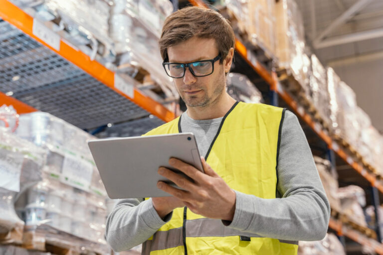 man-with-tablet-working-logistic business owner managing financing inventory in warehouse for growth